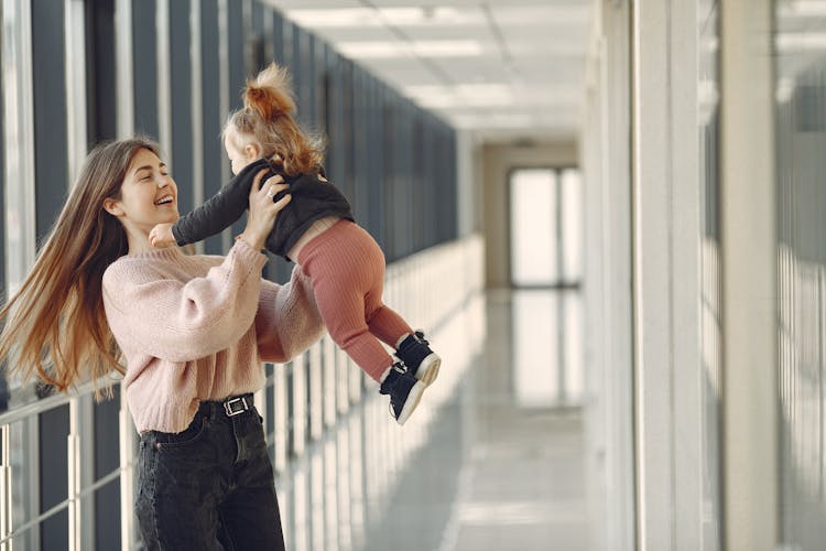 Excited Mother Spinning Around With Daughter