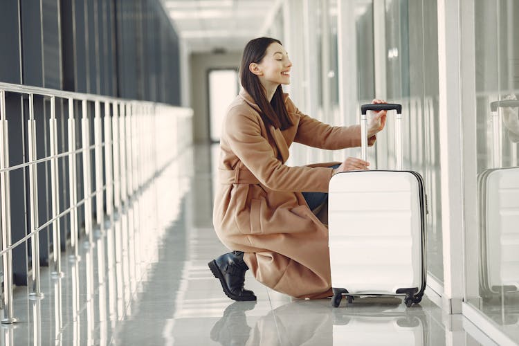 Excited Woman With Luggage In Airport