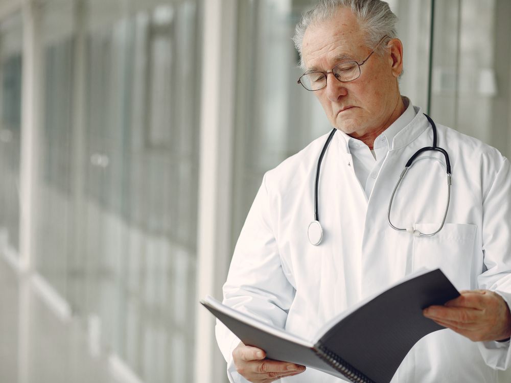 Physician with medical papers