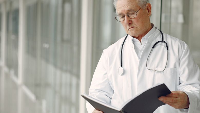 Physician with medical papers