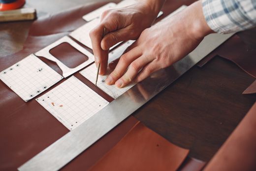 Cutting a belt strip from a hide, photo by Gustavo Fring on Pexels