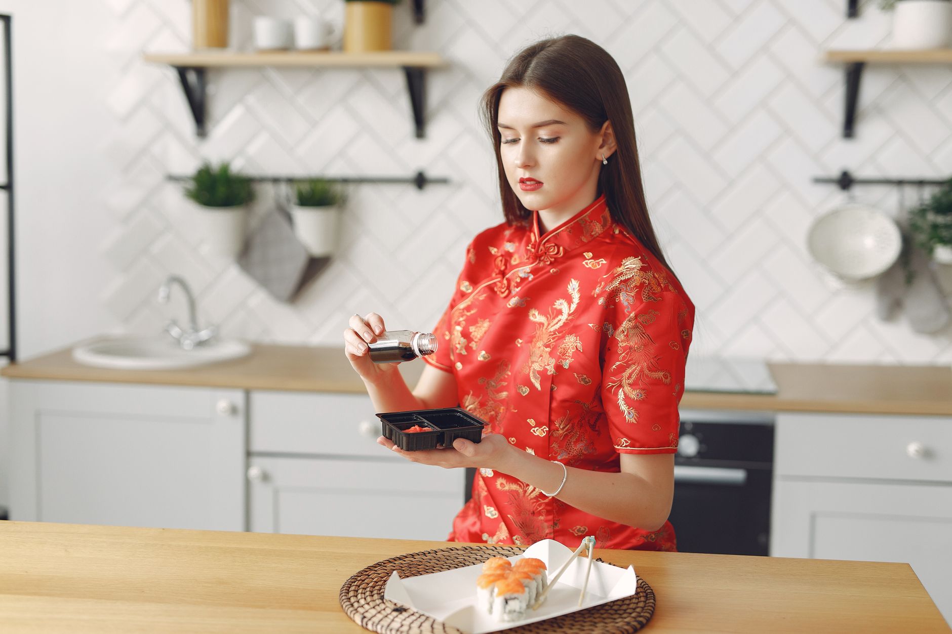 bottle of soy sauce with food on kitchen table