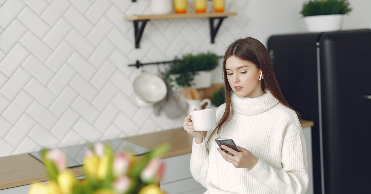 woman drinking coffee morning routine sunlight kitchen