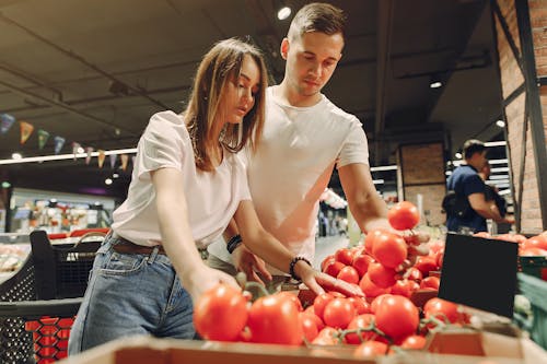 Happy couple choosing food in supermarket