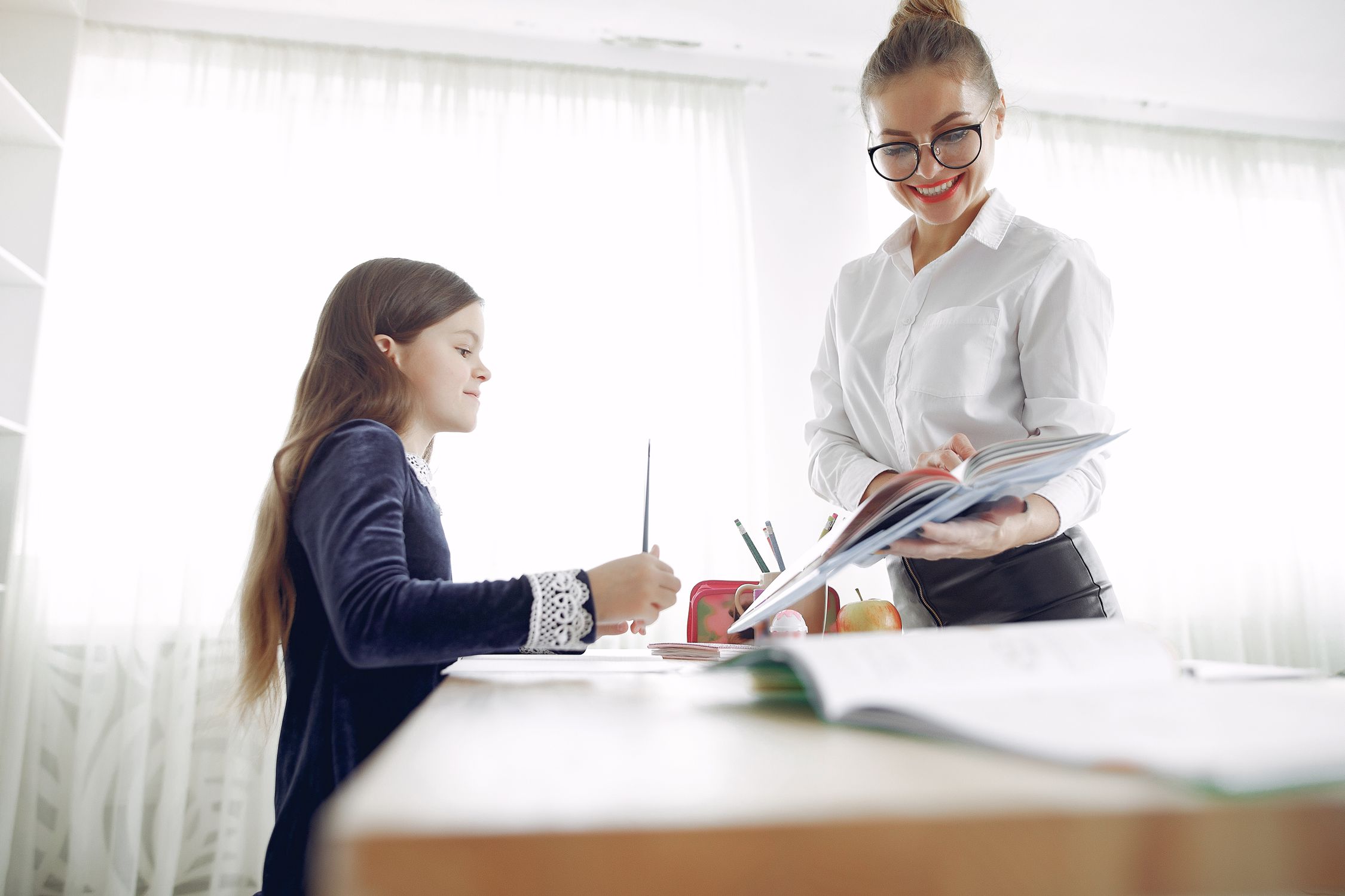 Happy tutor explaining lesson to pupil · Free Stock Photo