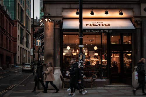 People Walking Outside a Coffee Shop