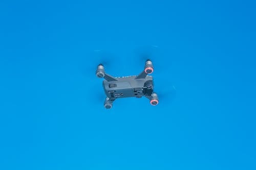 Free From below of side part of remote control drone with quickly spinning propellers and small cameras for taking photos and videos Stock Photo