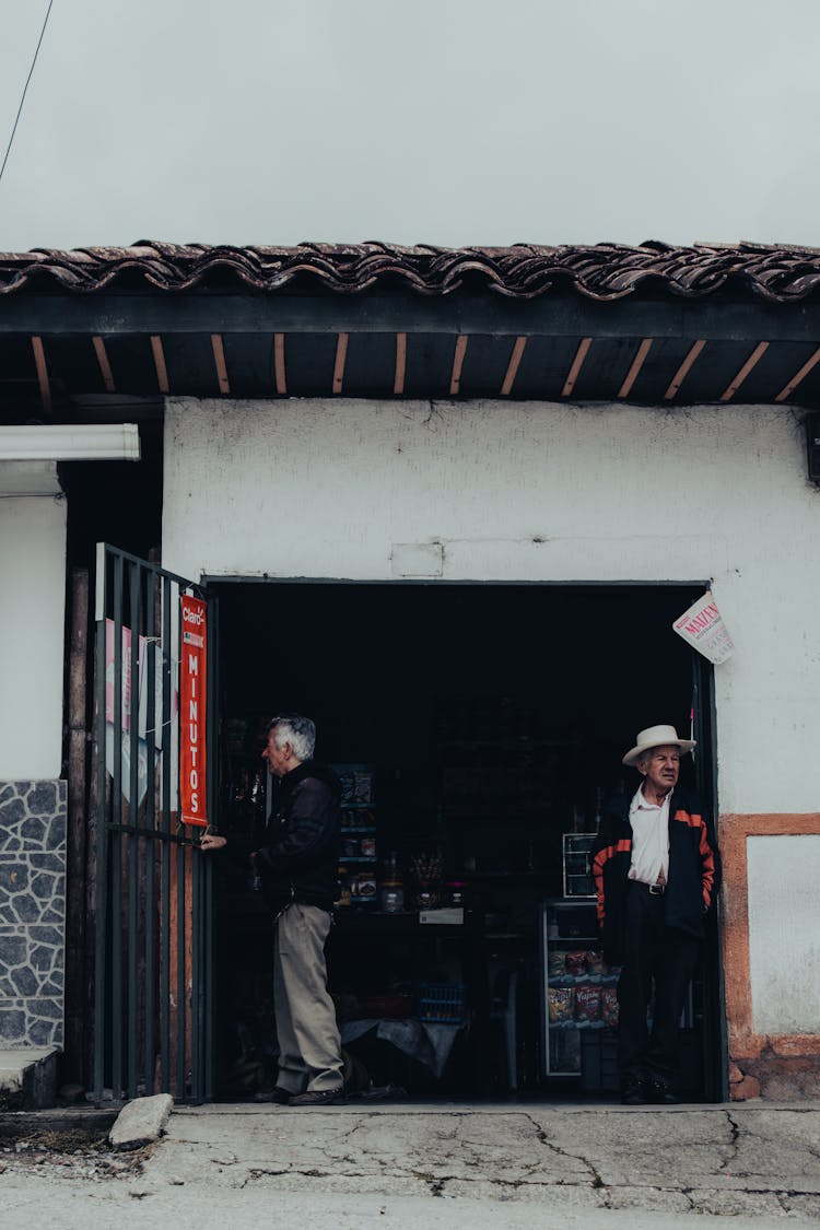 Senior Men Standing Near Entrance Of Store