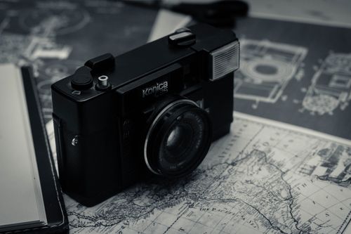 Free Vintage photo camera and old map placed on table near opened notebook Stock Photo