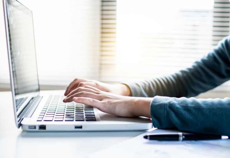 Close-up of hands typing on a laptop keyboard — photo by Khwanchai Phanthong on Pexels