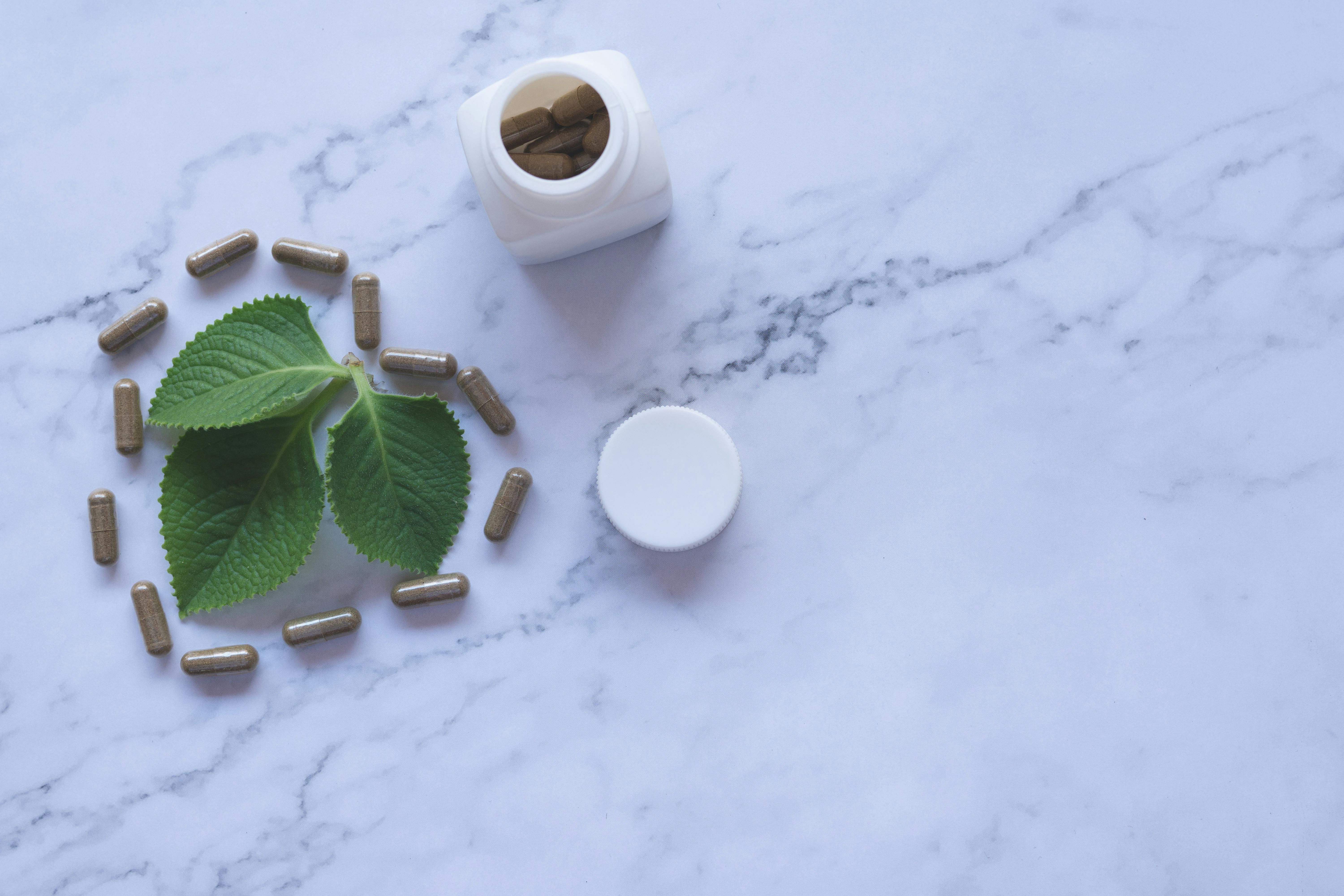 a bottle of capsules on a marble surface