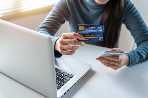 Free Woman Holding A Credit Card and Cellphone Stock Photo