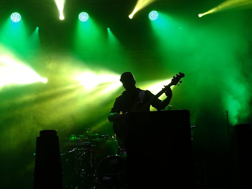 Man Playing Guitar on Stage