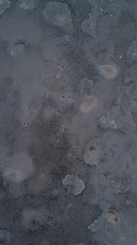 Aerial view of a dark textured concrete surface, perfect for background use.