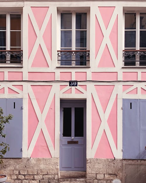 Building Exterior With Purple Wooden Door and Pink Wall