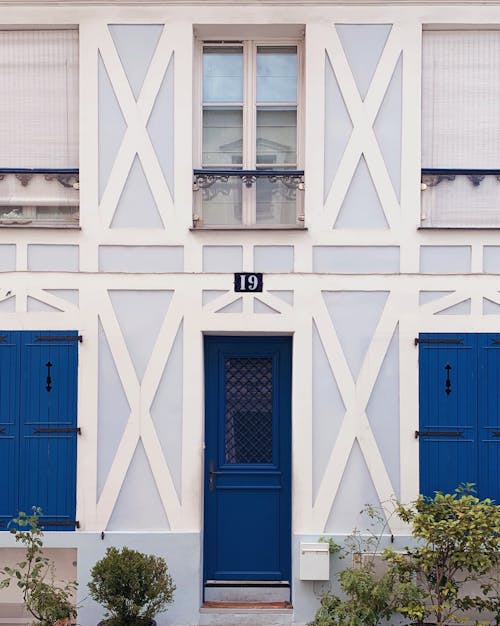 Building Exterior With Blue Wooden Door and White Wall