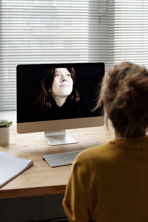 Woman in Yellow Shirt Having A Video Chat · Free Stock Photo