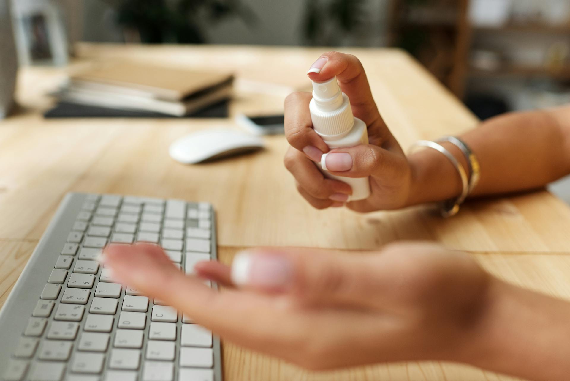 Person Spraying Sanitizer On Hand