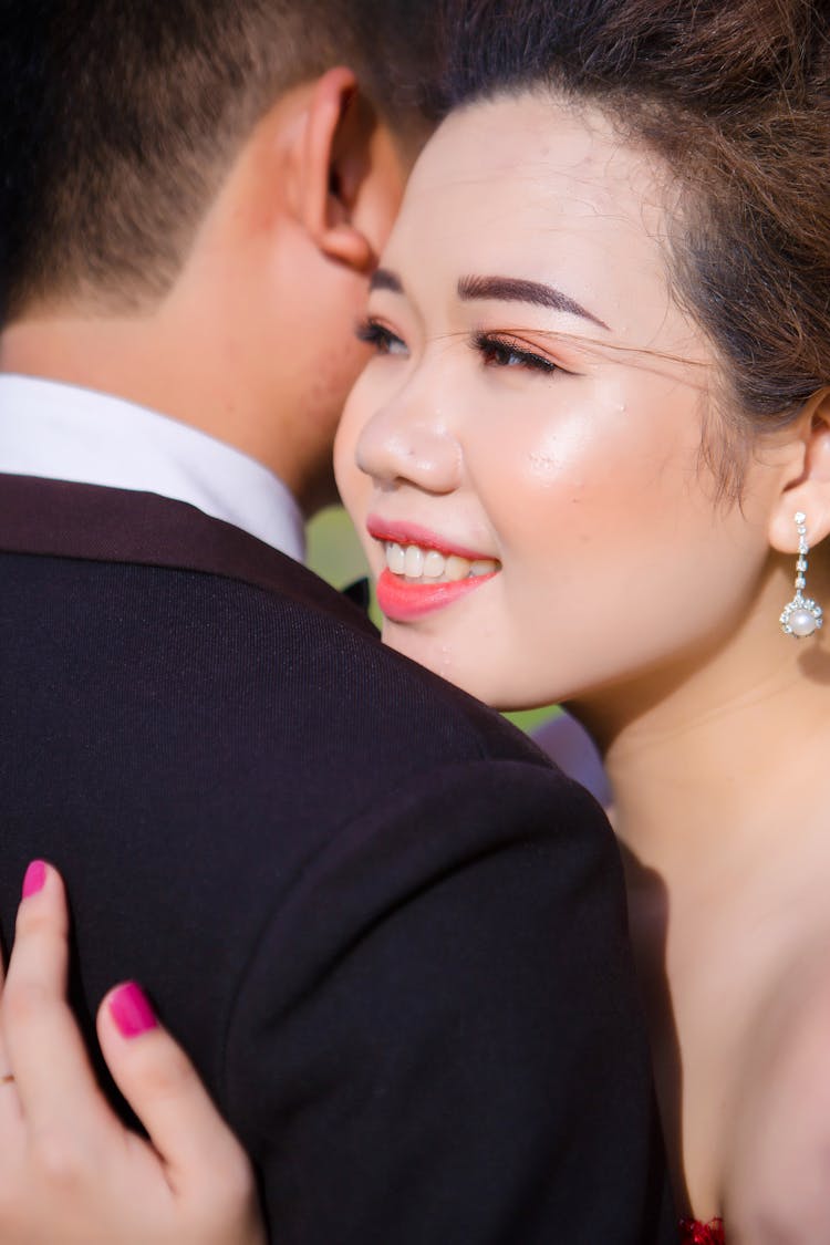 Crop Smiling Ethnic Wife Embracing Unrecognizable Husband After Getting Married