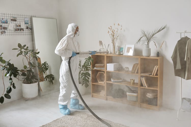 A Woman Fogging A Wooden Shelf 