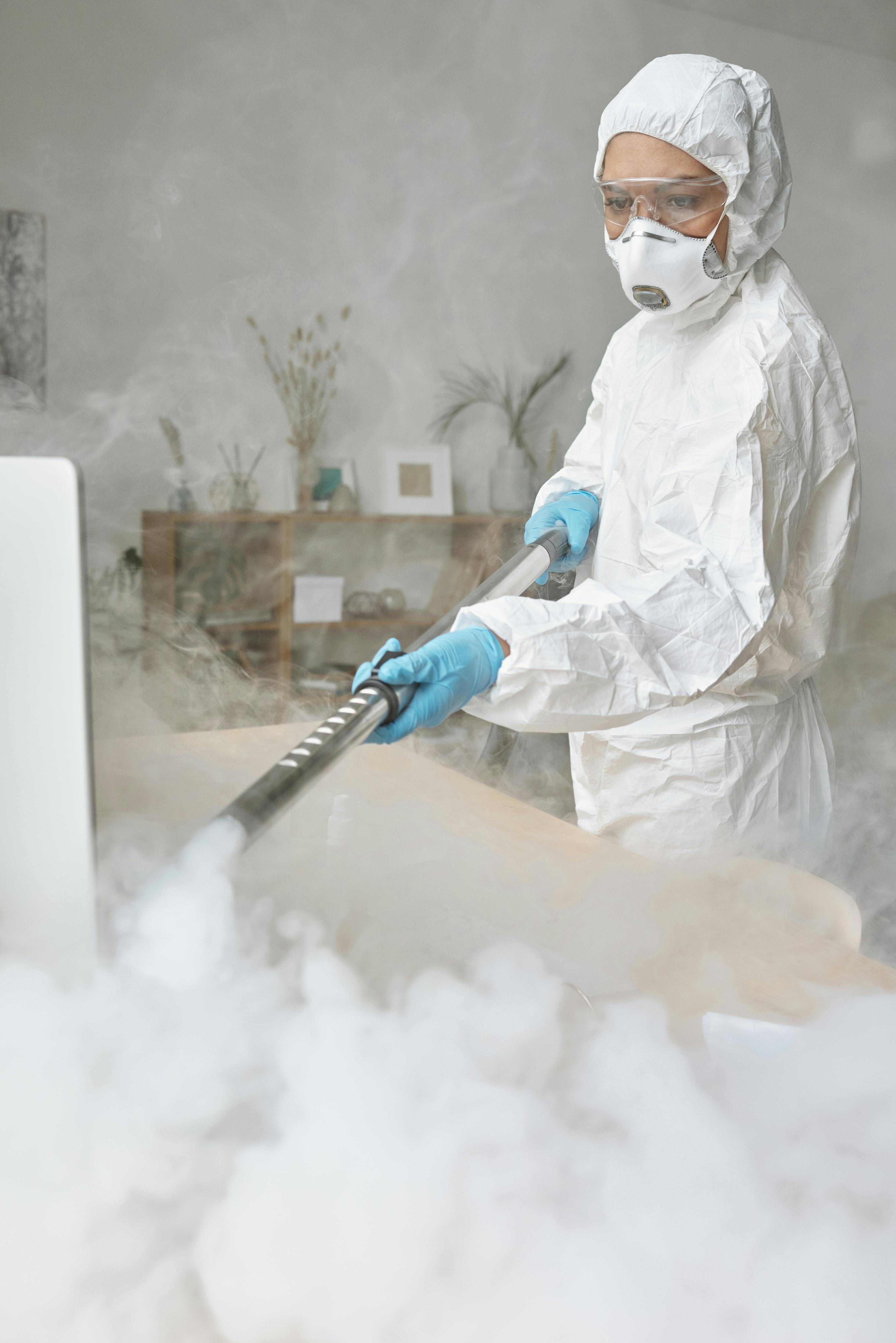 a woman disinfecting a table