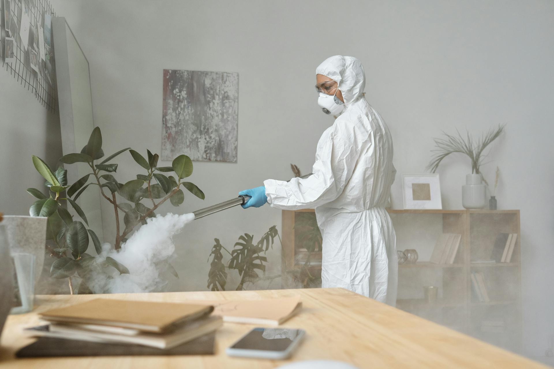 A Woman Disinfecting While in a Personal Protective Equipment