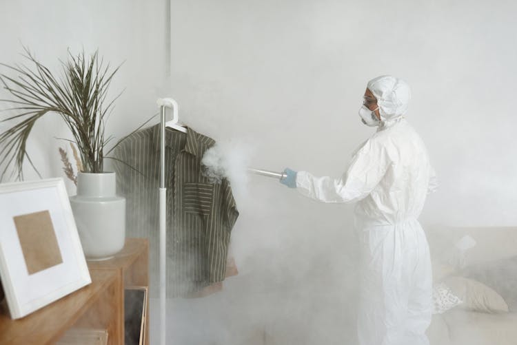 A Woman Disinfecting Clothes