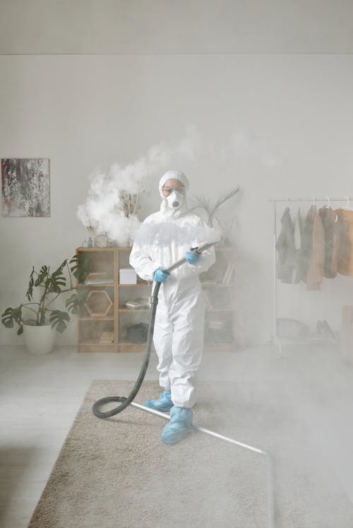 A Woman in PPE Fumigating 