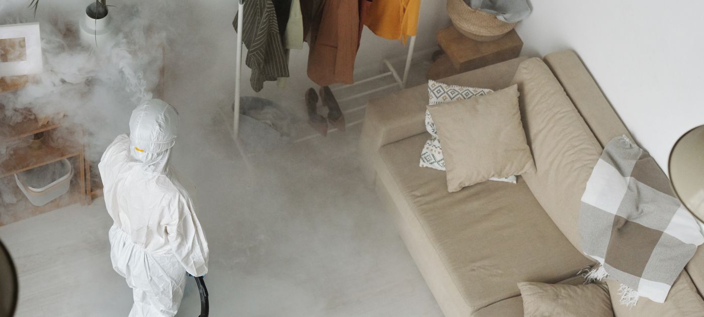 A technician treating the interior of a Malaysian home during a routine pest control visit