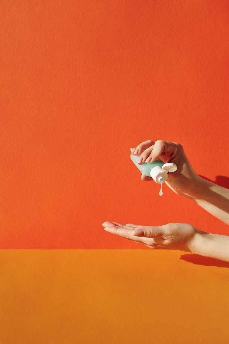 Hands Of A Woman Holding A Bottle Of Sanitizer