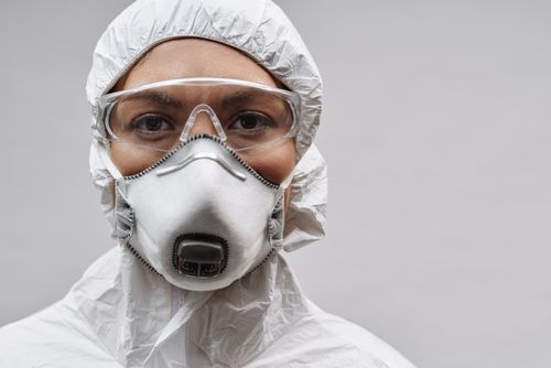 Free Close-up of a healthcare worker wearing a protective suit, mask, and goggles. Stock Photo