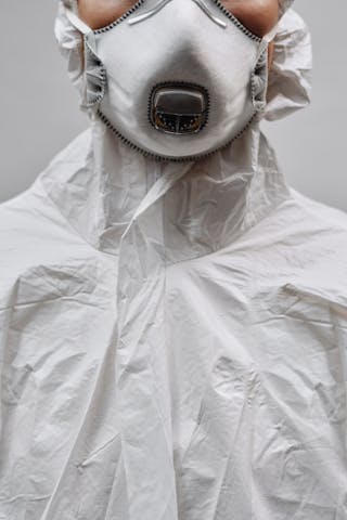 A detailed close-up image showing a person wearing protective clothing and a mask.