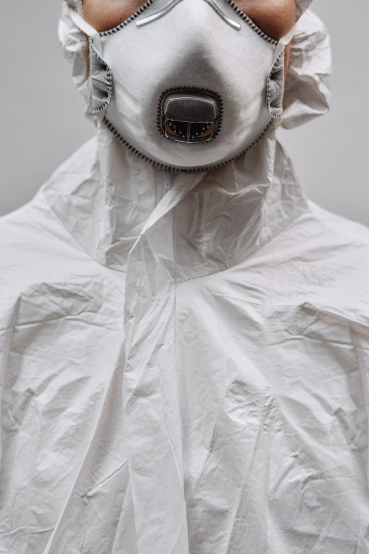 Person In White Gas Mask And White Protective Clothing