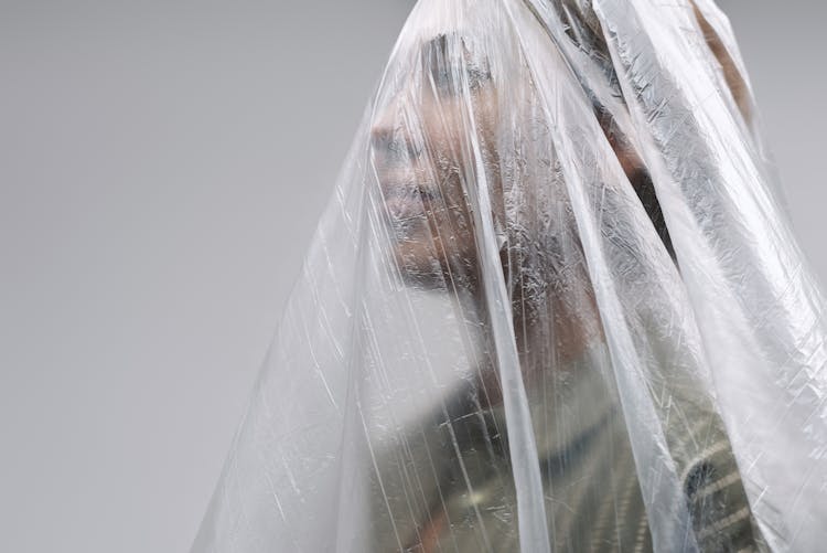 Woman Under A Clear Plastic Blanket Over Head