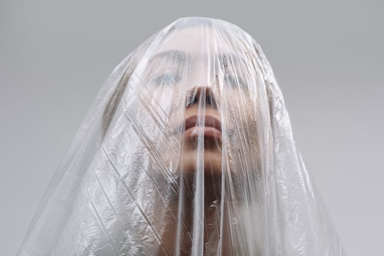 Face Of A Woman Covered With Clear Plastic Sheet