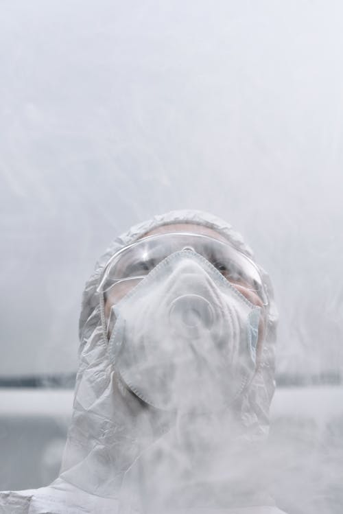 Free Person Wearing White Mask and Protective Goggles Stock Photo