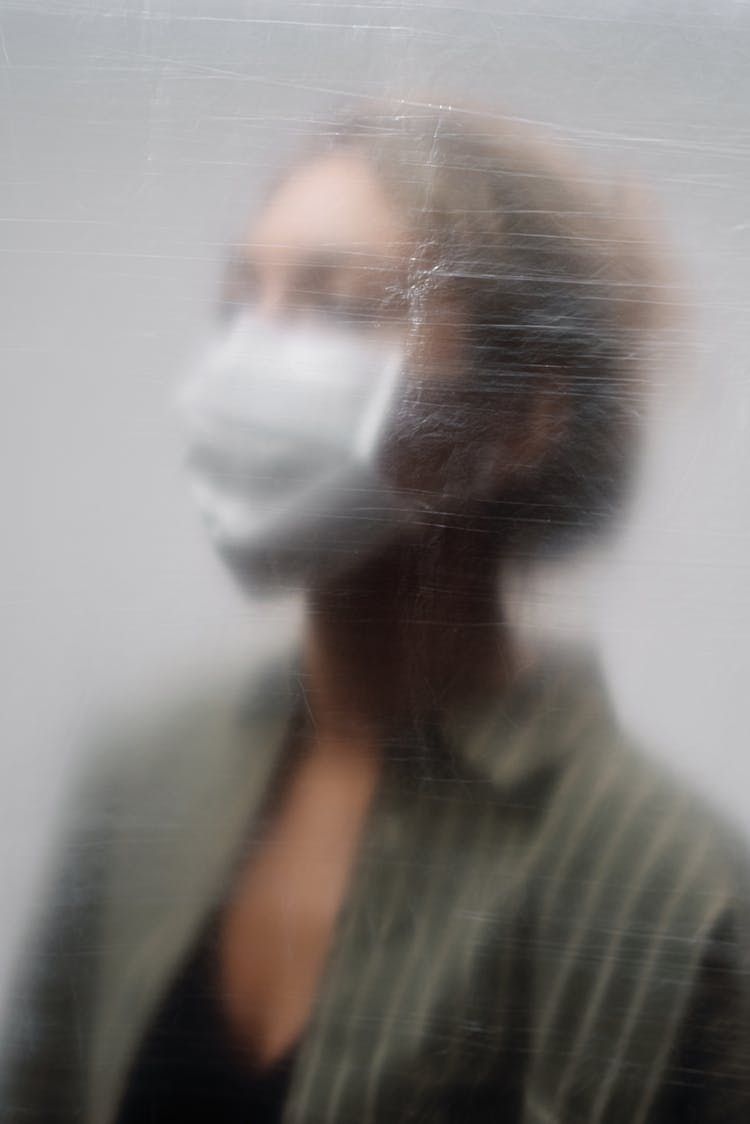 Woman In Green And White Stripe Shirt Behind Plastic Sheet