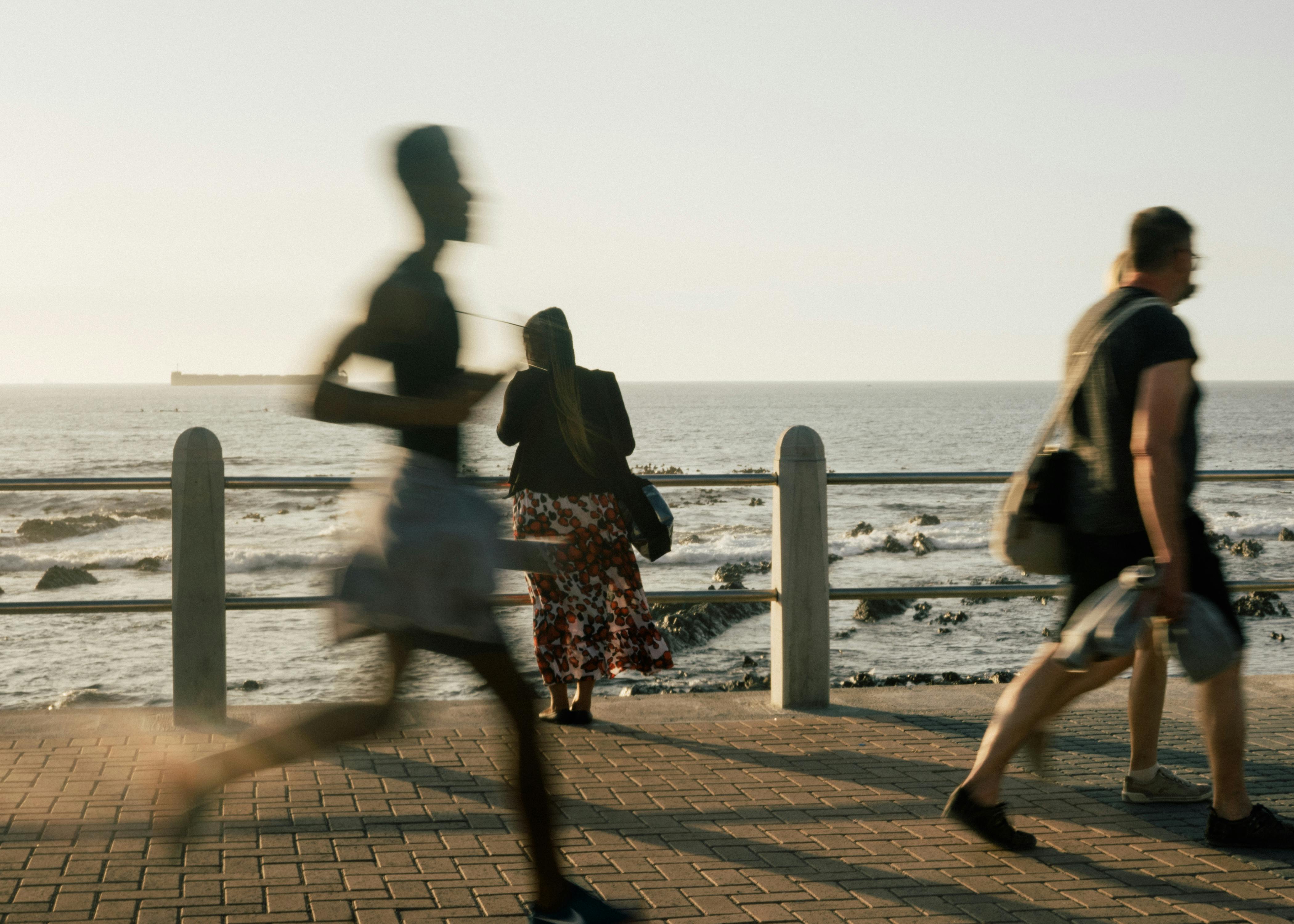 woman standing on background while people walking on promenade