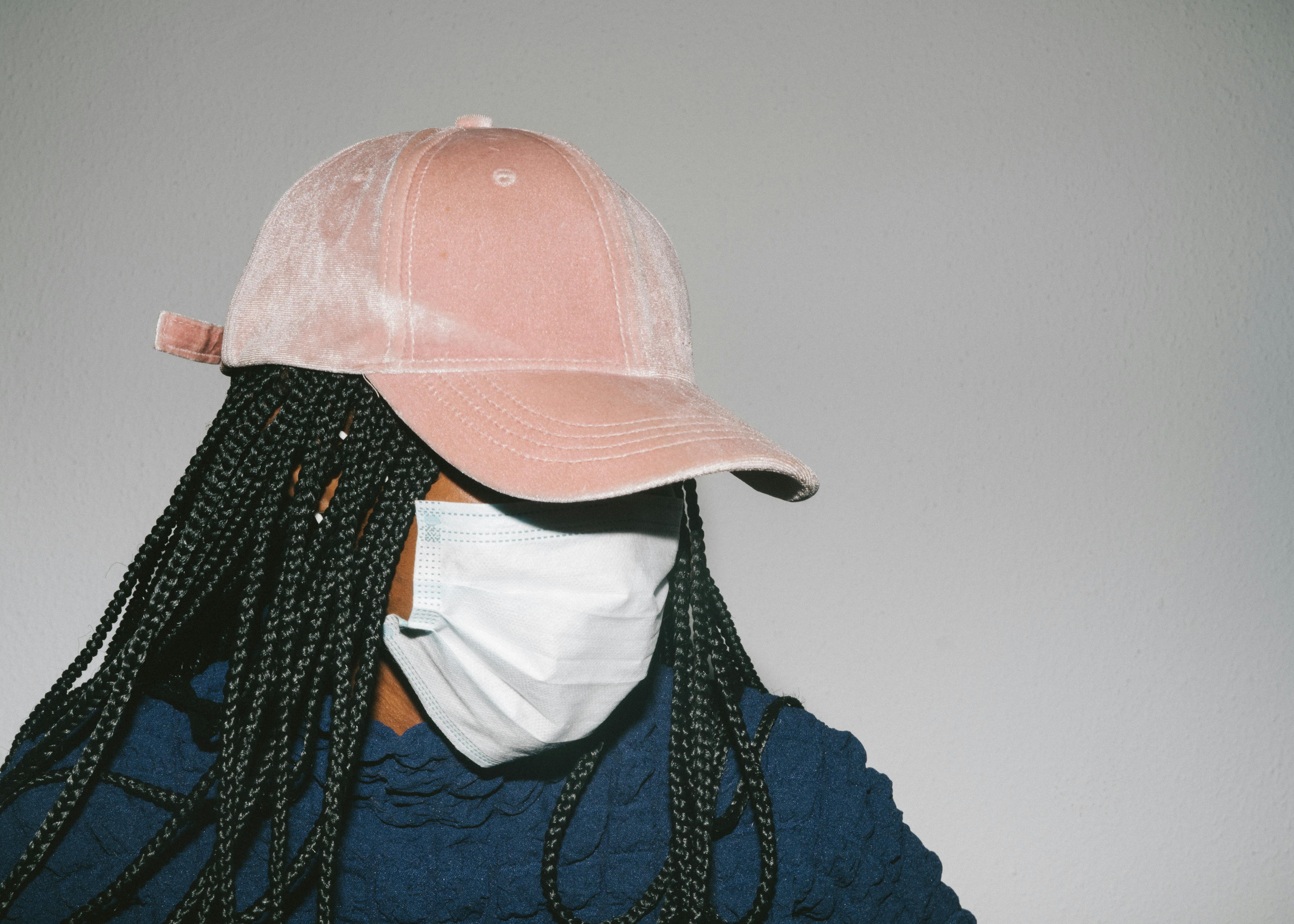 black woman in protective mask on gray background