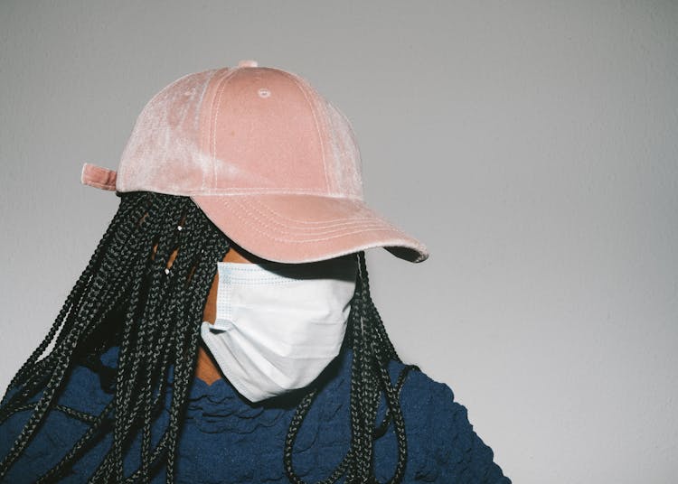 Black Woman In Protective Mask On Gray Background