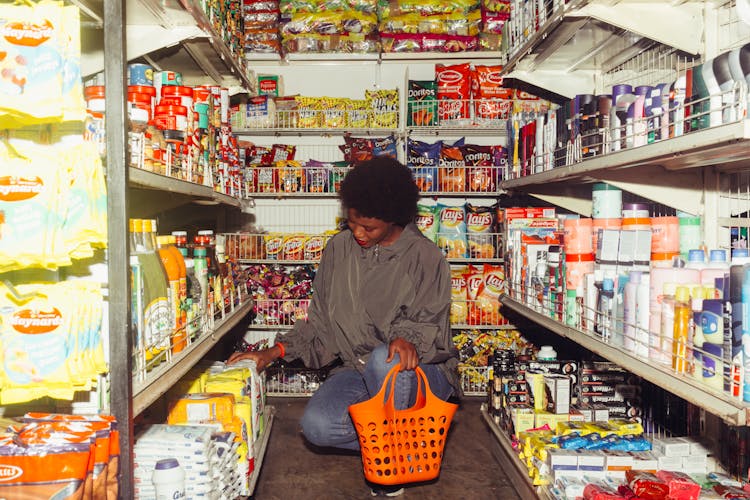 Woman Buying Groceries In A Convenience Store