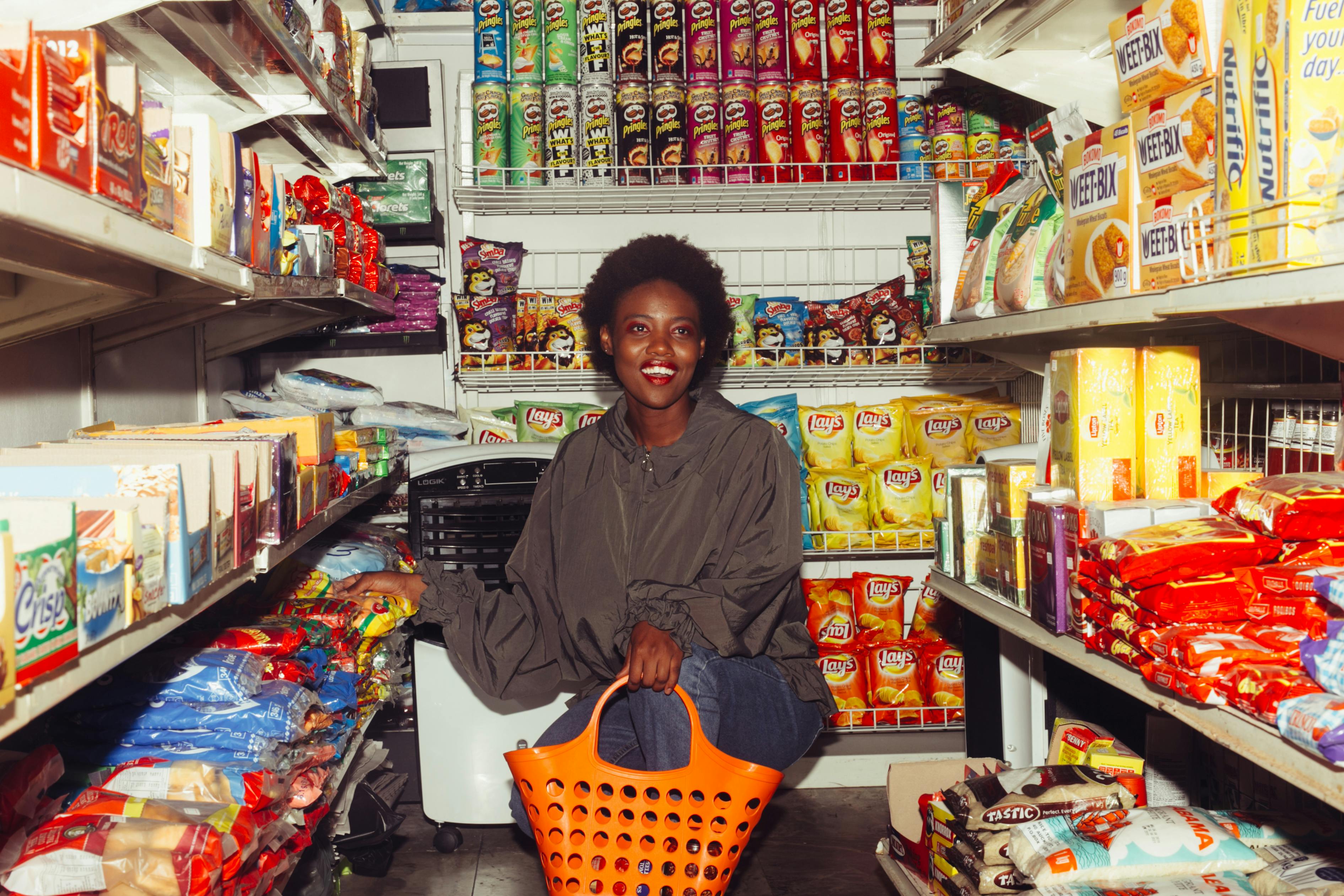 happy woman buying groceries in a convenience store