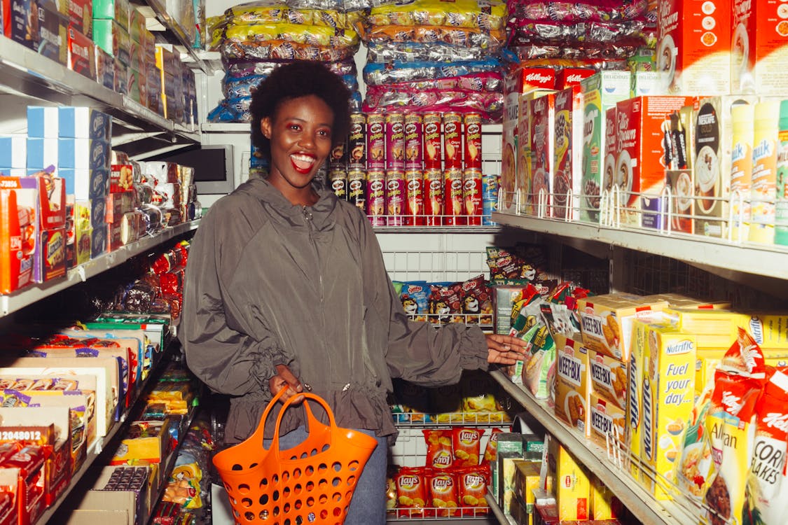 Free Happy Woman Buying Groceries in a Convenience Store Stock Photo