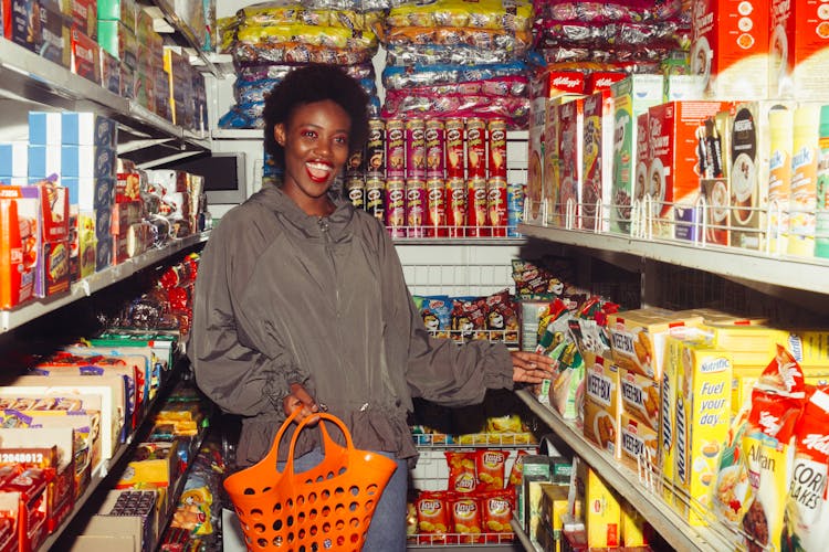 Happy Woman Buying Groceries In A Convenience Store