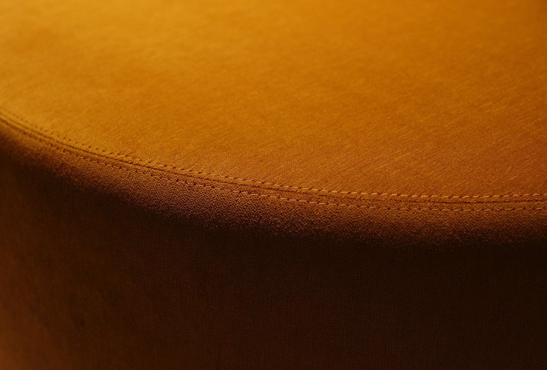 Close-up of a garment's interior seam finishing, showing the construction detail the five-context rubric asks the reader to examine before purchase to assess formal-context qualification