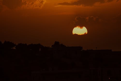 Free Bright moon over city at dusk Stock Photo