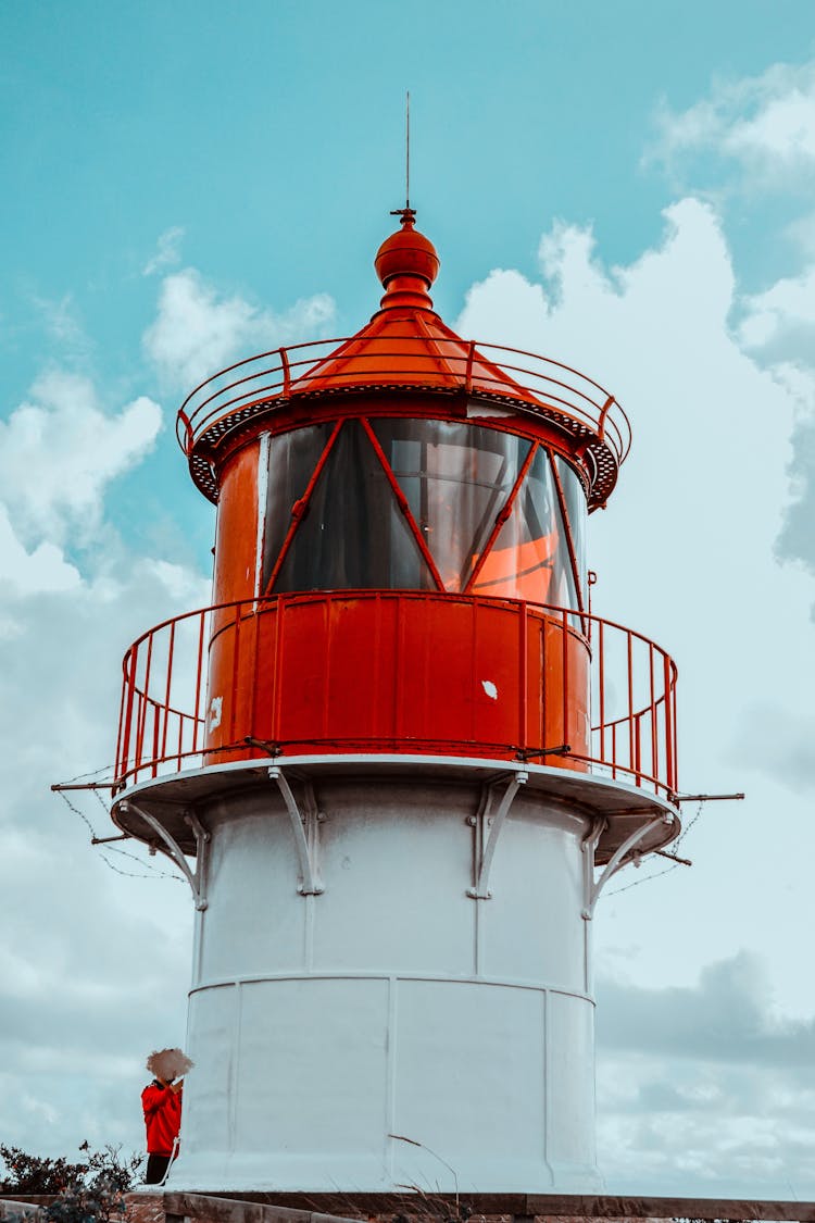 White And Red Lighthouse Under Blue Sky