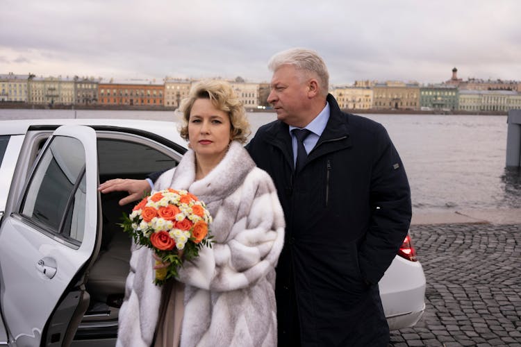 Couple Of Mature Lovers Standing Near Car