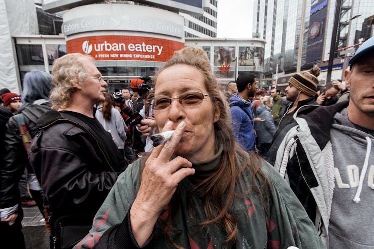 Cheerful Mature Woman Smoking In City