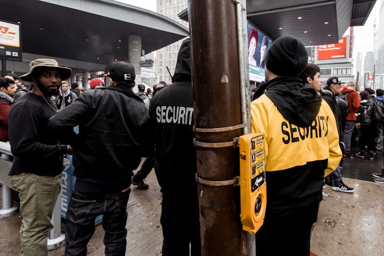 Crowded Guarded Street In City